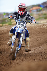 Image showing Motorcross, dirt road and athlete riding bike with speed for a race or sports competition. Challenge, fitness and man biker on motorcycle for adrenaline, training or practicing on outdoor mud trail.