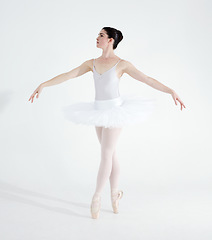 Image showing Dance, ballet and performance with woman in studio for balance, elegant and creative. Artist, theatre and training with ballerina dancing ion white background for competition, freedom and commitment