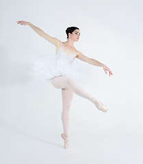 Image showing Dance, ballet and elegant with woman in studio for balance, creative and performance. Artist, theatre and training with ballerina dancing ion white background for competition, freedom and commitment