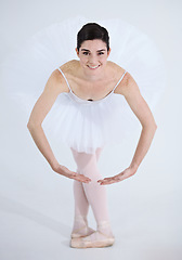 Image showing Portrait, dance and ballet with a woman in studio on a white background for rehearsal or recital for theatre performance. Art, creative and smile with a happy young ballerina or dancer in uniform