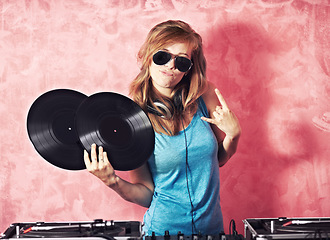 Image showing DJ woman, mixer and portrait with vinyl records, sunglasses and horns sign at club, studio or party. Girl, music director and party with rock icon, turntable or attitude for event, celebration or job