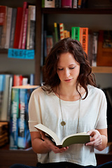 Image showing Woman, book and reading in a store, library or bookstore customer and student with a novel to buy, read or study. Girl, bookshelf and studying books for college, university or research information