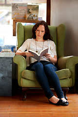 Image showing Education, woman reading a book and sitting on a couch at a local bookstore. Research or learning, studying or research and female person read a textbook or notebook on a sofa for knowledge.