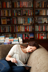 Image showing Relax, literature and woman reading a story for knowledge while sitting on a sofa in library. Calm, happy and female person with a smile enjoying a fantasy book or novel on couch in bookstore or shop