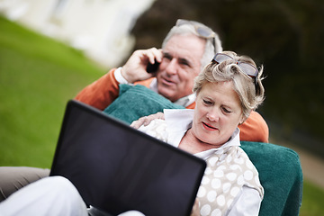 Image showing Phone call, laptop and travel with an old couple in a hotel garden for vacation at a luxury resort. Love, technology or communication with a senior man and woman tourist outdoor on grass at a lodge