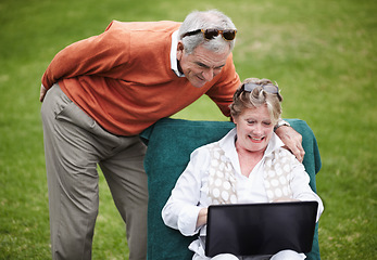Image showing Love, laptop and an old couple in the garden of a hotel for travel or vacation at a luxury resort. Retirement, technology or social media with a senior man and woman tourist on the grass at a lodge