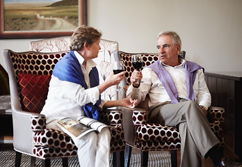 Image showing Toast, love and an old couple drinking wine in their hotel room while on holiday or vacation together. Retirement, sofa or relax with a senior man and woman bonding at a luxury resort for romance