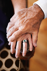 Image showing Closeup, holding hands and senior couple with support, empathy and comfort with care, solidarity and loving together. Zoom, fingers and old woman with elderly man, romance or love with trust or grief