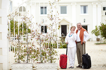Image showing Travel, hotel and senior couple relax on vacation with suitcase in a holiday location happy in retirement together. Bag, smile and elderly people on a journey or man and woman pointing in happiness