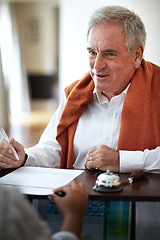 Image showing Hotel, reception and an old man signing documents for check in at a luxury hospitality resort for vacation. Paper, signature and travel with a happy senior male tourist in a lodge for holiday travel