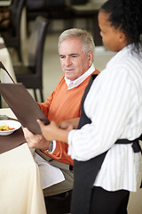 Image showing Waitress, hotel and senior man in a restaurant for breakfast or lunch at a hotel with a menu and choice of food. Friendly, order and elderly person happy on vacation or holiday for hospitality