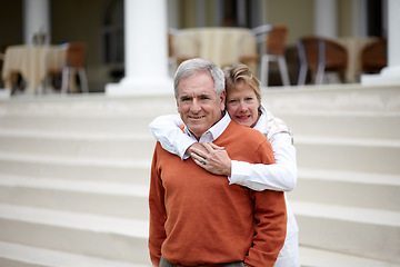 Image showing Hug, portrait and an old couple on hotel steps for travel, vacation or tourism in luxury accommodation. Love, retirement or hospitality with a senior man and woman hugging on a resort staircase