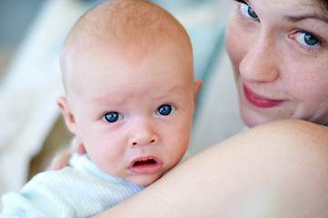 Image showing Kid, portrait and mom holding baby, bonding and care together in home. Face, child and mother carrying newborn, infant or young toddler, playing and enjoying quality time with love, family and happy.