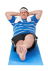 Image showing Fitness, overweight and man doing a exercise in a studio for weight loss, health or wellness. Sports, obesity and fat male person doing a sit up body workout on yoga mat by isolated white background.