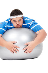 Image showing Tired, plus size and man on exercise ball feeling fatigue from training and workout in studio. Lazy, thinking and rest of a male person doing weight loss and wellness practise on gym equipment