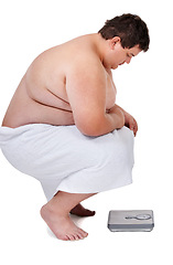 Image showing Scale, plus size and man checking number and weight loss progress in a studio. White background, male person and profile of a heavy set model looking at health and wellness results with a towel