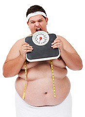 Image showing Overweight, scale bite and man upset with diet progress and weight loss goal in studio. White background, hungry and model with plus size stomach with body problem and health issue with towel