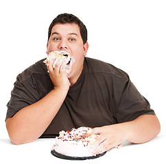 Image showing Cake, obesity and overweight man eating desert or unhealthy diet isolated in a studio white background. Hungry, face and portrait of a person with mouth full with sweets, sugar and calories