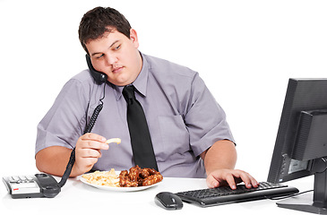 Image showing Phone call, eating and plus size business man in studio on computer with food, lunch and unhealthy meal at desk. White background, office mockup and male worker with weight problem for for sales job