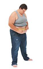 Image showing Obesity, measuring tape on abdomen and man checking diet, stomach size and body health isolated on white background. Healthcare, measure stomach for weight loss progress and male on studio backdrop.