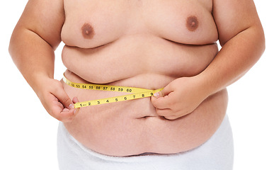 Image showing Overweight, tape measure and man checking wellness progress and weight loss goal in studio. White background, hands and model with plus size stomach with body problem and health issue with towel