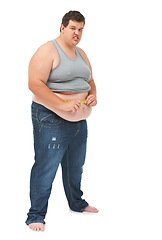 Image showing Obesity, tape measure on abdomen and portrait of angry man checking size, body health and isolated on white background. Frustrated male, measuring stomach and weight loss progress on studio backdrop.