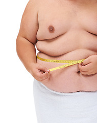 Image showing Overweight, tape measure and man checking diet progress and weight loss goal in studio. White background, hands and model with plus size stomach with body problem and health issue with towel