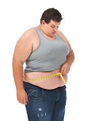 Image showing Obesity, tape measure on stomach and man checking waist size, body care and isolated on white background. Male measuring abdomen for weight loss progress, healthcare and motivation on studio backdrop