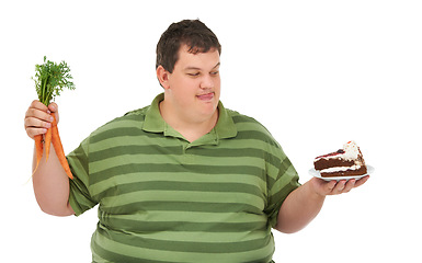 Image showing Plus size, hungry decision and man with carrot and dessert choice thinking about food. Male model, studio and white background with healthy and cake order with weight loss and nutrition balance idea