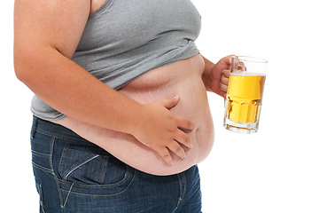 Image showing Beer, weight gain and plus size stomach in a studio with alcohol problem with gut health issue. Heavy, overweight and drinking carbs with unhealthy body and alcoholic drink with high calories