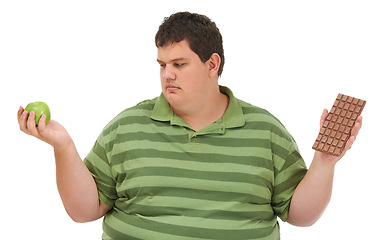 Image showing Plus size, diet decision and man with a apple and candy choice thinking about balance. Male model, studio and white background with healthy and chocolate with weight loss and nutrition problem