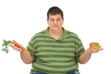 Image showing Plus size, diet decision and man with a carrot and fast food choice thinking about balance. Male model, studio and white background with healthy and take away order with weight loss and nutrition