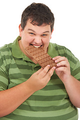 Image showing Plus sized, chocolate and portrait of happy man with eating unhealthy diet, smile and isolated on white background. Nutrition, weight loss and food addiction, face of male model with candy in studio.