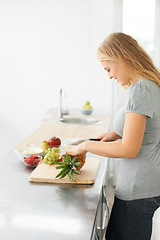 Image showing Woman, healthy cooking and fruit for eating food and nutrition for weight loss diet and health at home. Kitchen, cut fruits and produce in a house with breakfast and nutritionist in the morning