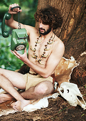 Image showing Caveman, forest and modern artifact holding a phone feeling curious outdoor in the woods. Bone necklace, wilderness and first man with technology and communication discovery of a person in nature