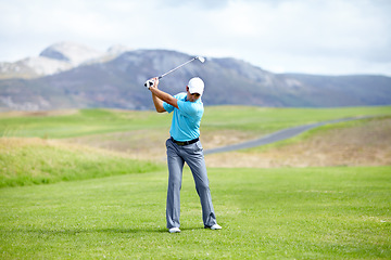 Image showing Fitness, man or golfer playing golf for fitness, workout or exercise with a swing on a green course. Wellness, person golfing or athlete training in action or sports game driving with a club stroke