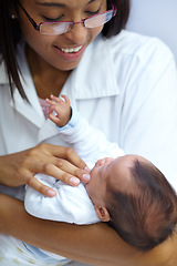 Image showing Healthcare, smile and a pediatrician with a baby in the hospital for insurance, care or treatment. Medical, children and a happy doctor woman in glasses holding a newborn infant in a health clinic