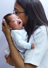 Image showing Healthcare, cleft palate and a pediatrician with a baby in the hospital for insurance, care or treatment. Medical, kids and a doctor woman holding a newborn with a disability in a health clinic