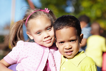 Image showing Happy, children and portrait of friends at a park playing outdoor at break time at kindergarten. Happiness, smile and kids embracing and having fun together in nature on the playground at school.