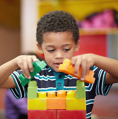 Image showing Plastic building blocks, school and boy with education, learning and happiness with safety, relax and kindergarden. Male child, kid and toddler in a classroom, fun and creative student in a creche