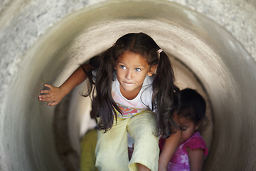 Image showing Playground, children and play in tunnel, explore or having fun together. Kindergarten, tube and young girl, kids and friends playing game, adventure or learning, education and enjoying time at school