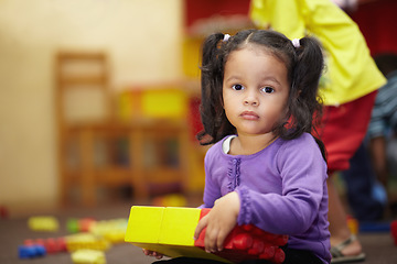 Image showing Learning, building blocks and child portrait in school, classroom and education for kindergarten development. Face of girl or kid playing in creche for mind, motor skills and creative games