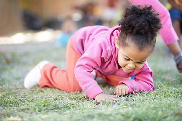 Image showing Field, grass and girl with fun, curious and happy in the garden, nature and springtime with joy. Female person, happy toddler or infant in the backyard, outdoor or kindergarden with child development