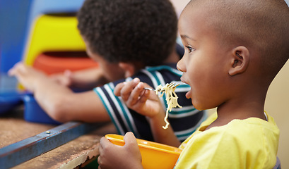 Image showing Child, lunch and eating in school, kindergarten or classroom and healthy nutrition, food and noodles. Kids, black boy and hungry kid or eat snack, pasta in lunchbox or breakfast in kindergarden