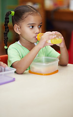 Image showing Drink, juice and girl in kindergarten with food for nutrition at school for learning in class . School, drinks and kid at table in classroom with sandwich for an education to learn at creche.