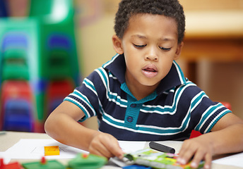 Image showing School, focus and a child drawing in a class for education, learning and creativity. Table, creative and a little male student doing art at kindergarten or creche to learn about color and playing