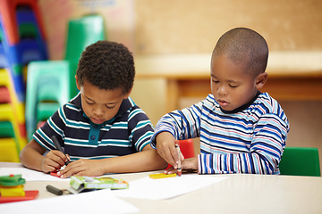 Image showing Drawing, art and children in class for learning, studying or education at kindergarten. Focus, table and boy students with paper at school for creche work, creativity and a classroom activity