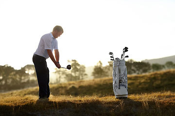 Image showing Golf, stroke and man with driver outdoor on course for training, workout or fitness at sunset mockup space. Golfing, club and person swinging for game, competition or exercise, sports and wellness.