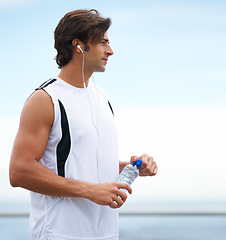 Image showing Thinking, fitness and a man with water and music after running, exercise or outdoor cardio. Break, relax and a runner with a drink while listening to a podcast after training or sports in nature