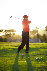 Image showing Golf, stroke and man with club on course outdoor for training, workout or fitness on sunset mockup space. Golfing, driver and person swinging for game, competition or exercise, sports and lens flare.